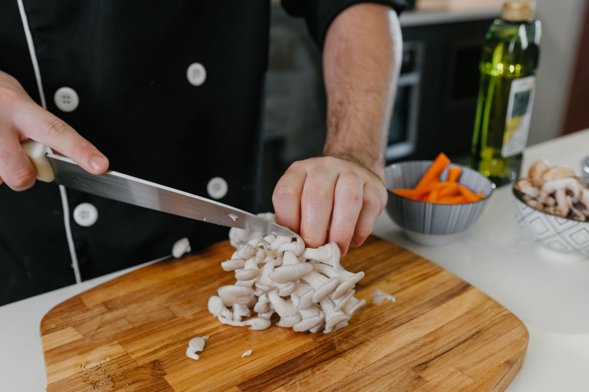 hands mixing white grain spawn into a mushroom grow bag